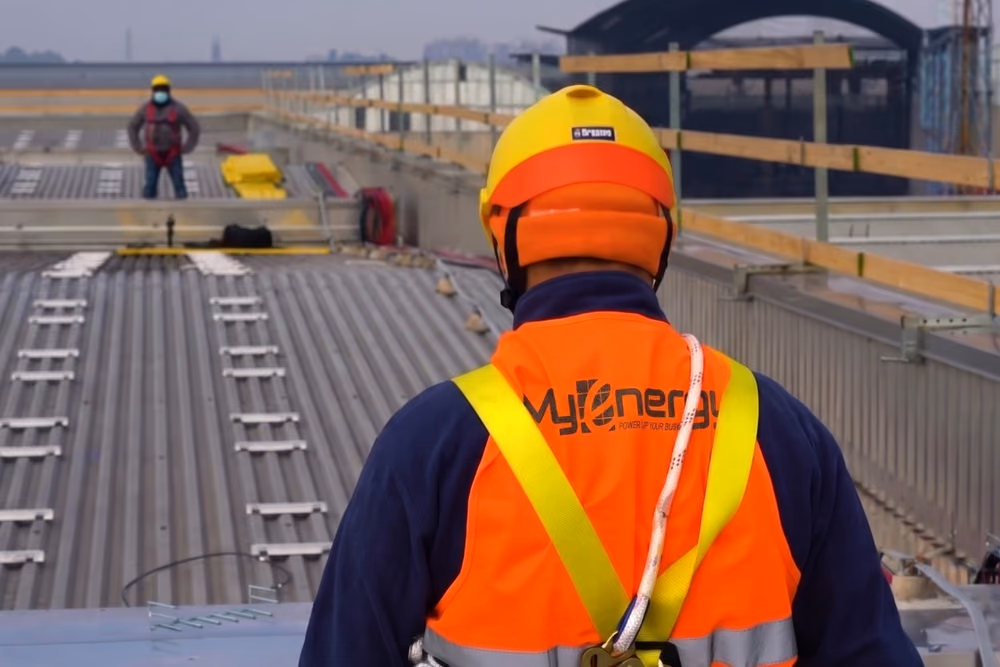 Tecnico Myenergy con l'imbragatura sul tetto di un cantiere